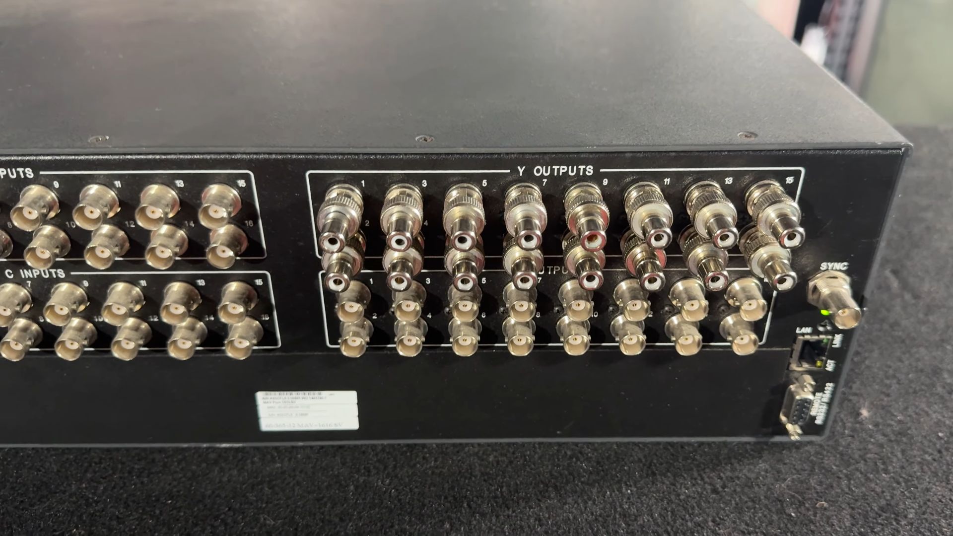 The rear of the Extron matrix switcher shows multiple BNC connectors for Y and C outputs, with all the outputs adapted to RCA connectors.