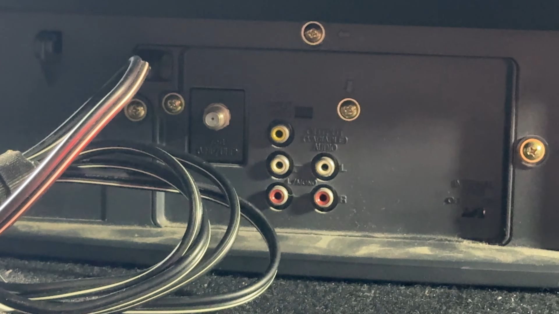 Close-up of the back panel of a vintage CRT television showing various input ports, including RF and RCA composite connectors.