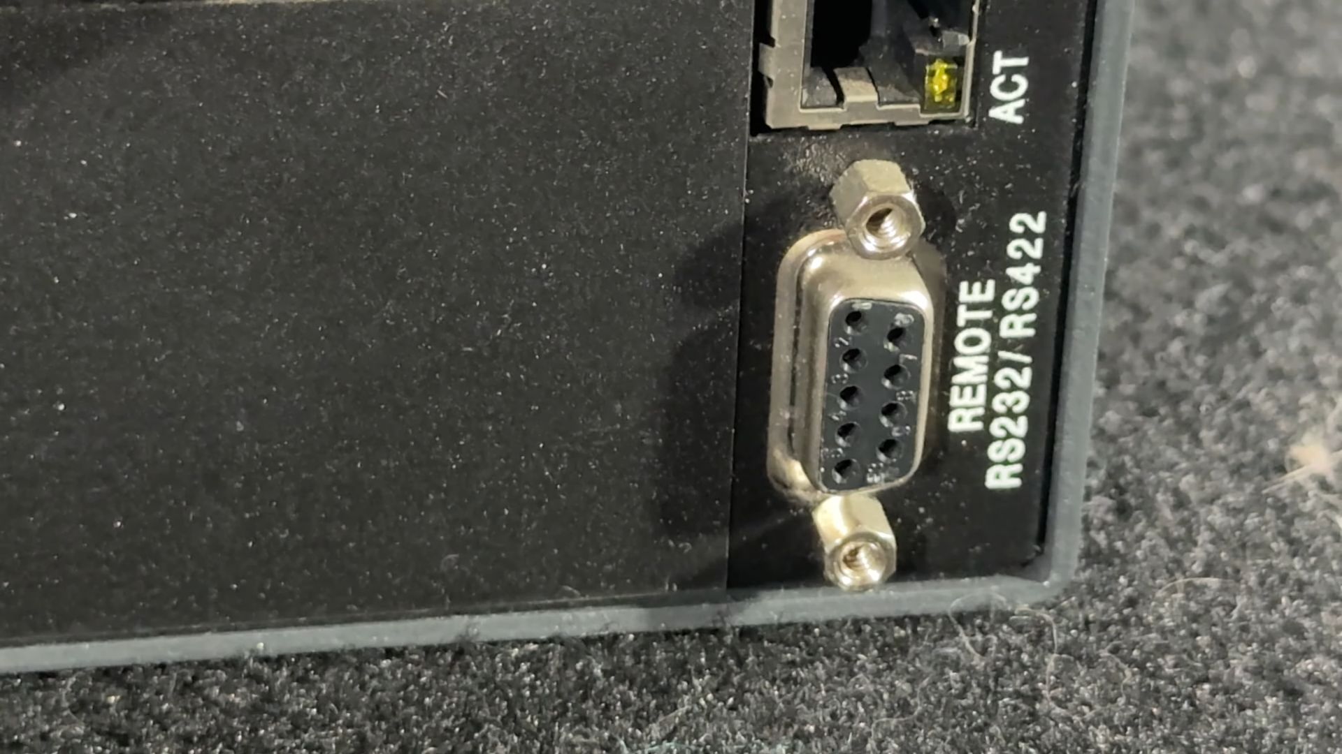 Close-up of the Extron matrix switcher rear panel, showing RS232/RS422 remote control port and an Ethernet port labeled "ACT."