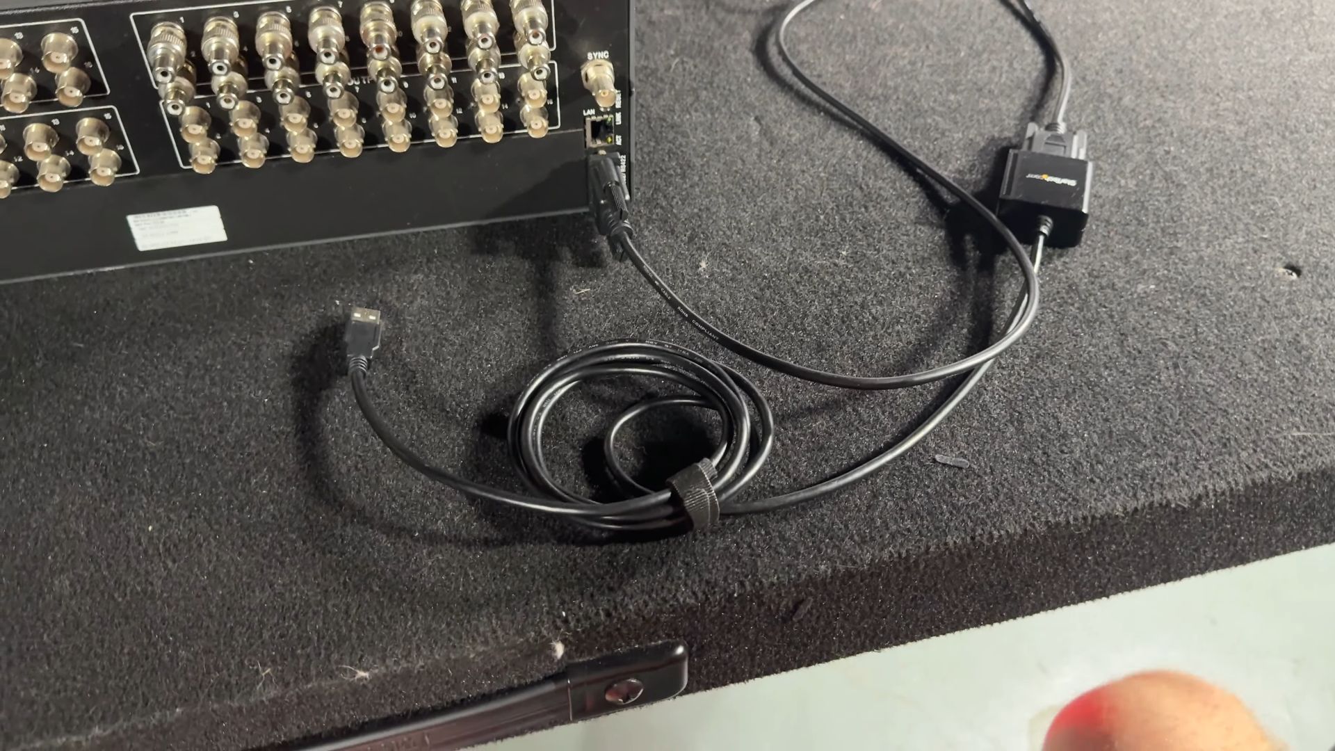 A serial to USB adapter cable is connected to the Extron matrix switcher, allowing for modern device interfacing.